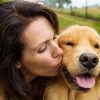woman kissing her dog