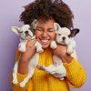 Woman holding two puppies